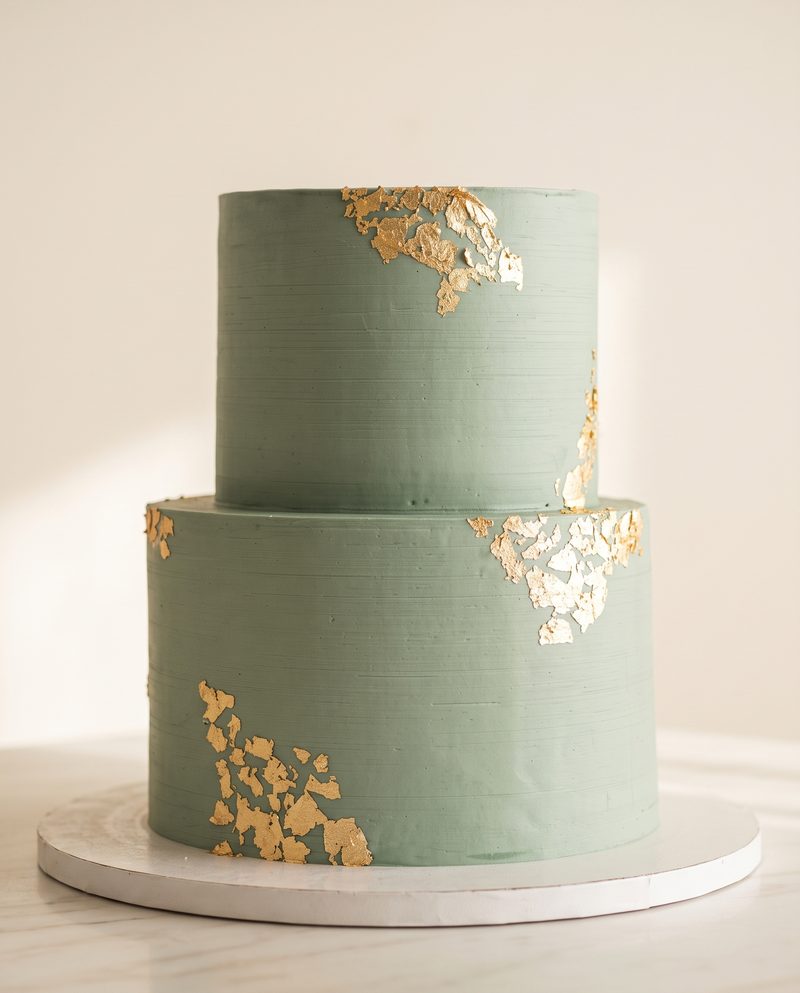 Gâteau vert sauge à deux étages rehaussé de feuilles d'or